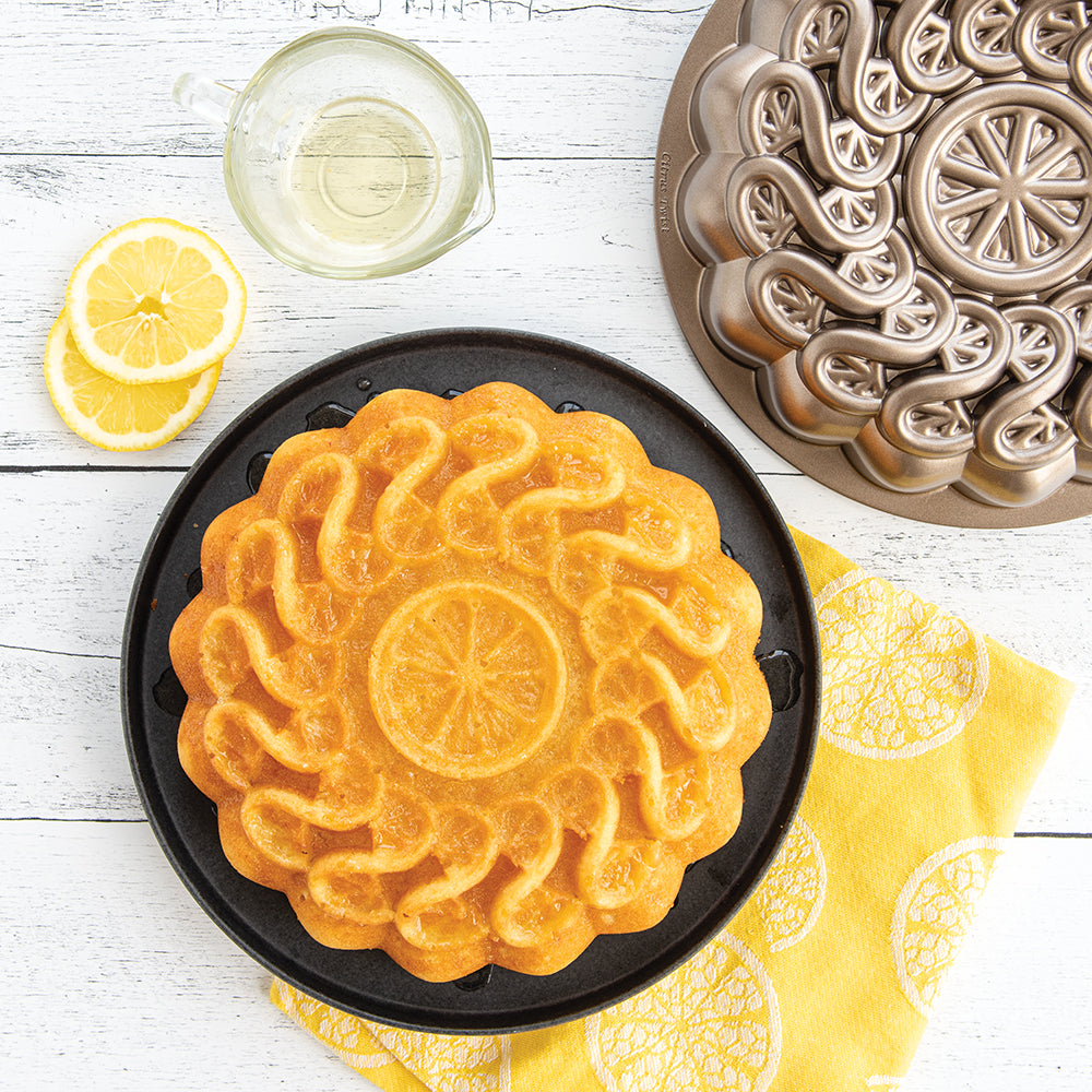 A beautifully baked Lemon Olive Oil Cake baked in the new Nordic Ware 8 Cup Citrus Twist Cake Pan.
