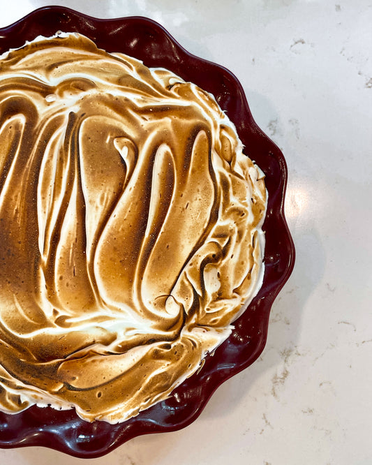 Toasted meringue on top of a S'mores Pie.